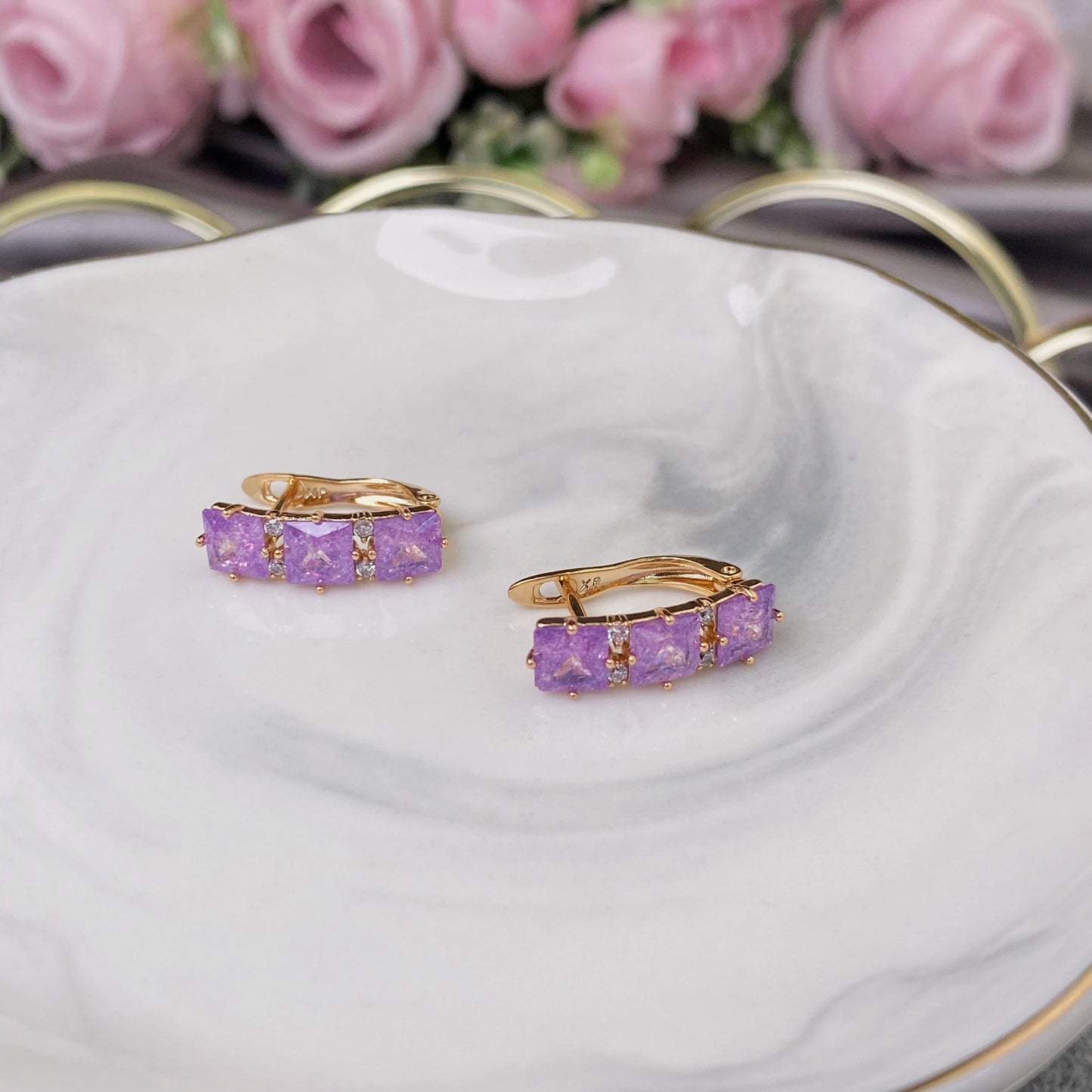 Gold plated earrings with violet decorative crystals